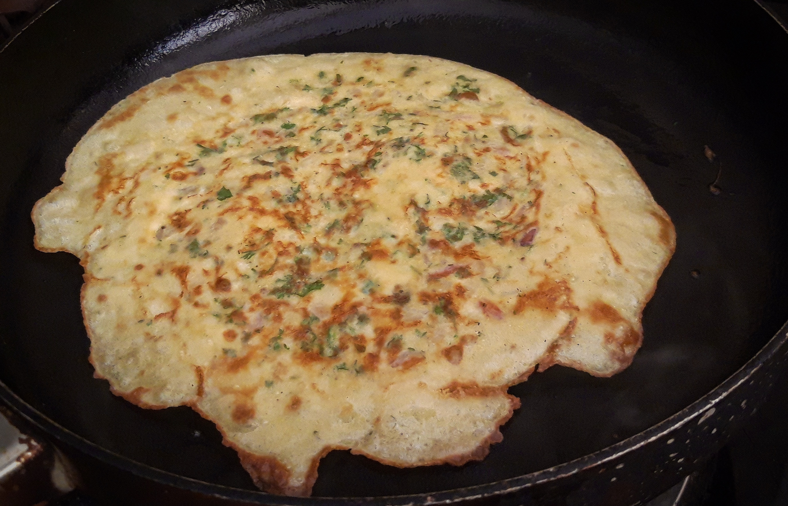 Indian Egg Omelette, contains chopped onions, green chilies, cilantro, etc. 