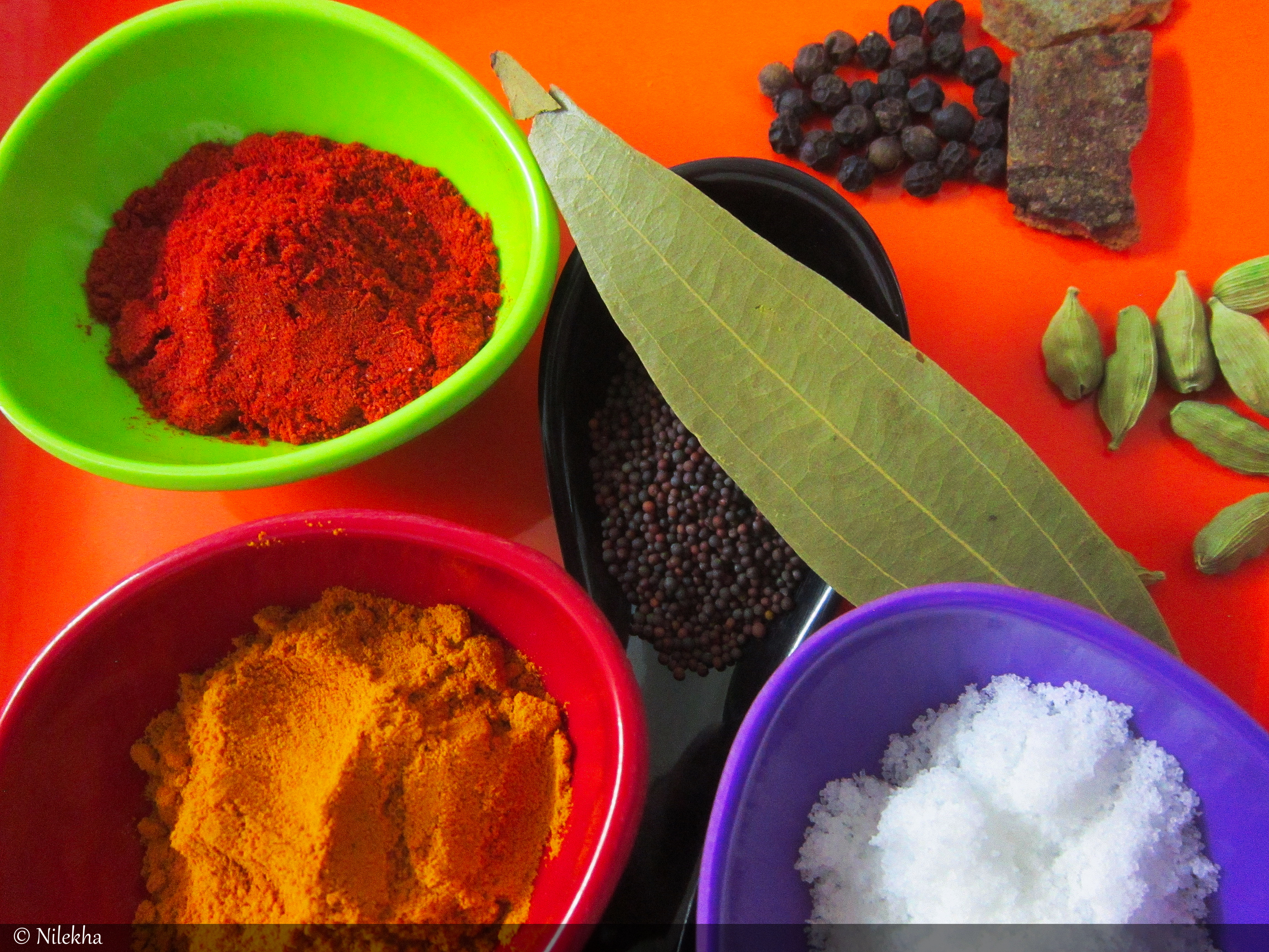 Indian Spices: Red Chilli Powder, Turmeric Powder, Salt, Mustard seeds, Dried Bay Leaf, Cardomom, Cinnamon, Peppercorns